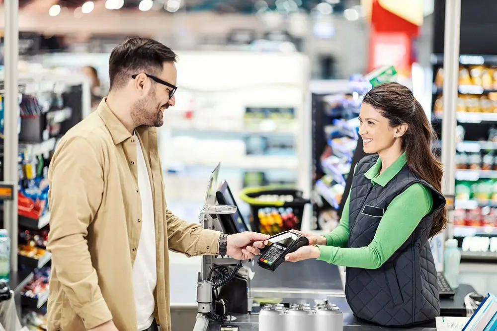 Customer purchasing a 6-pack of cans at major retailer